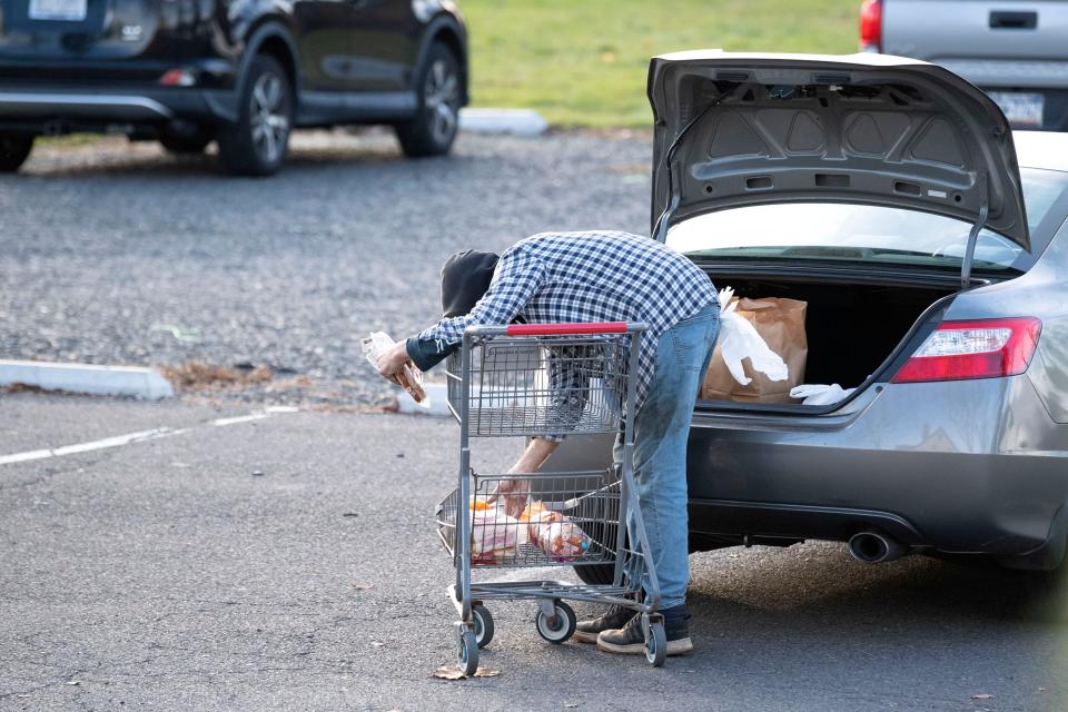 Community members pick up food items at Bucks County Housing Group food pantry in Langhorne on Tuesday, Nov. 29, 2022.