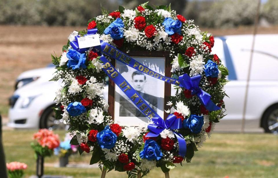 A funeral wreath circles a photo of Seaman 2nd Class Denver True “D.T.” Kyser at his graveside Saturday afternoon, May 21, 2022 at Fresno Memorial Gardens in Fresno.