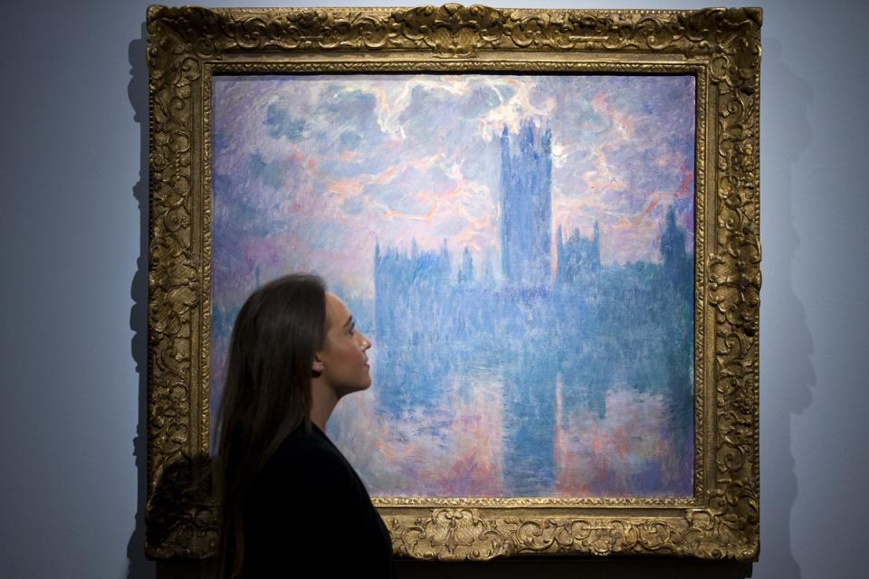 Christie’s employee looks at Monet’s ‘Le Parlement, soleil couchant’ (AFP via Getty Images)