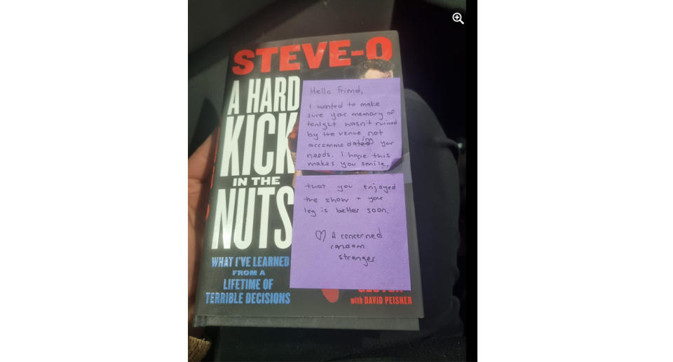 The cover of the black book is covered with two purple post-it notes with the handwritten message. 