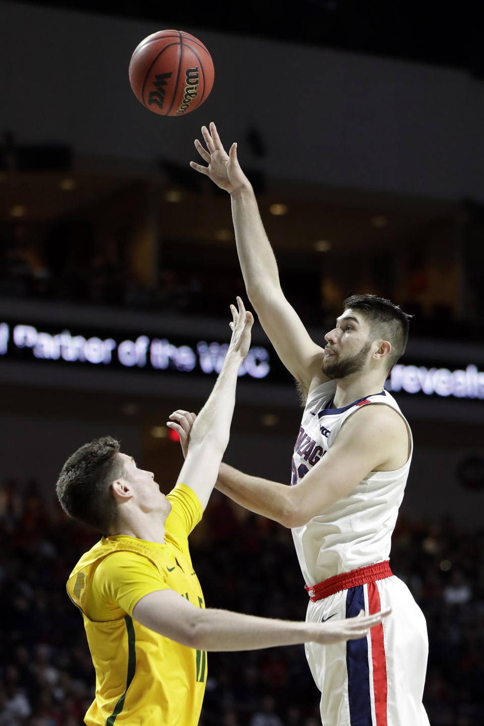 Gonzaga's Killian Tillie, right, shoots as San Francisco's Remu Raitanen defends during the first half of an NCAA college basketball game in the West Coast Conference men's tournament Monday, March 9, 2020, in Las Vegas. (AP Photo/Isaac Brekken)