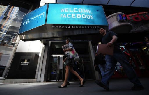 People walk past a sign welcoming Facebook at the NASDAQ stock exchange on Times Square in New York, on May 18. The spate of complaints and investigations over the Facebook stock offering suggests big institutions had an edge over small investors, raising questions about the process