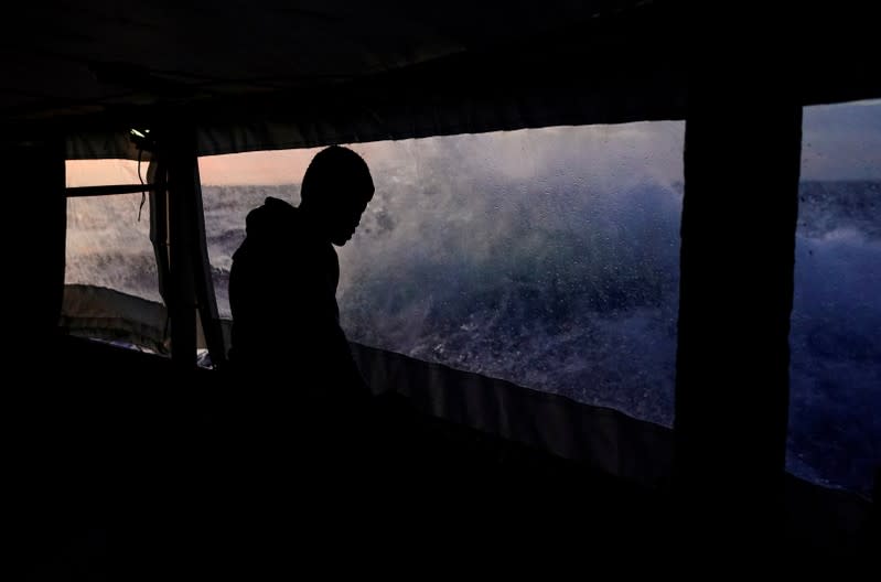 A migrant looks at waves on board of NGO Proactiva Open Arms rescue boat in central Mediterranean Sea