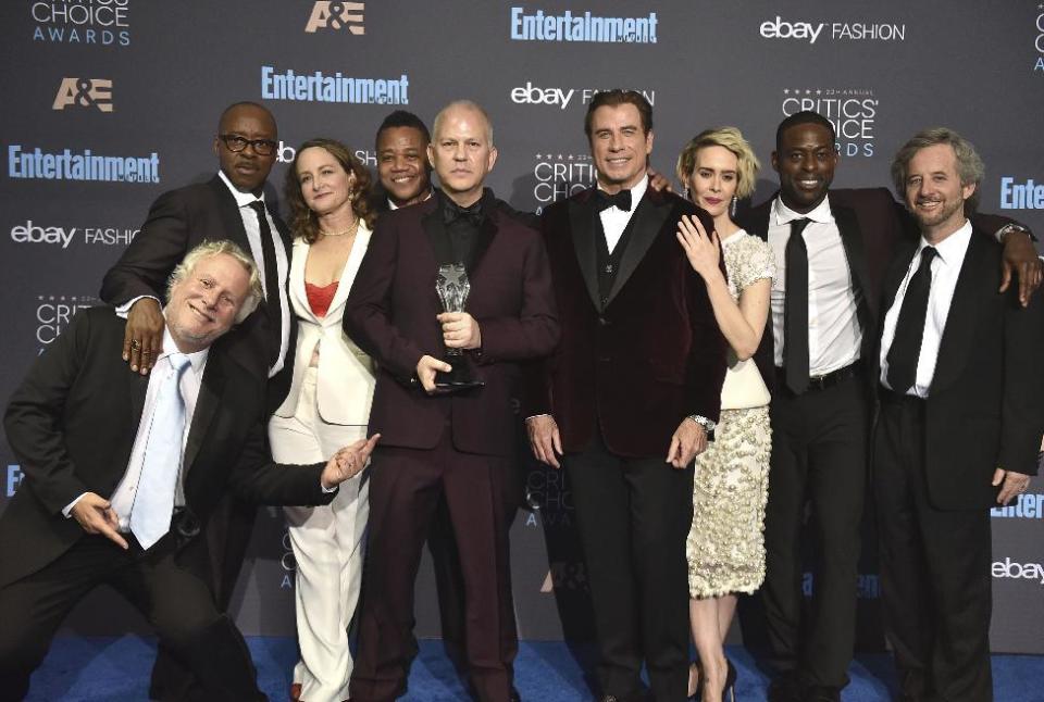 Larry Karaszewski, foreground from left, Courtney B. Vance, Nina Jacobson, Cuba Gooding Jr., Ryan Murphy, John Travolta, Sarah Paulson, Sterling K. Brown and Scott Alexander pose in the press room with the award for best movie made for television or limited series for "The People v. O.J. Simpson" at the 22nd annual Critics' Choice Awards at the Barker Hangar on Sunday, Dec. 11, 2016, in Santa Monica, Calif. (Photo by Jordan Strauss/Invision/AP)
