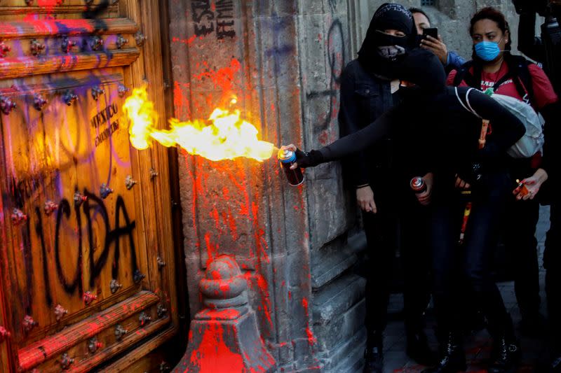 People take part in a protest against gender-based violence in downtown of Mexico City