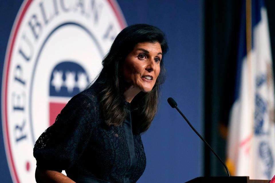 Nikki Haley standing in front of an Iowa Republican Party logo while speaking during the Iowa Republican Party's Lincoln Dinner,