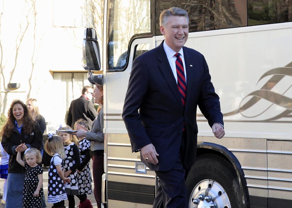 FILE - In this March 14, 2014 file photo, Rev. Mark Harris, right, who is seeking a Republican U.S. Senate nomination in the upcoming North Carolina primary, walks toward the podium during a campaign event supported by Michelle Duggar, left, standing with some of her 19 children, in Raleigh, N.C. The Duggars star in a reality TV show. (AP Photo/Ted Richardson)