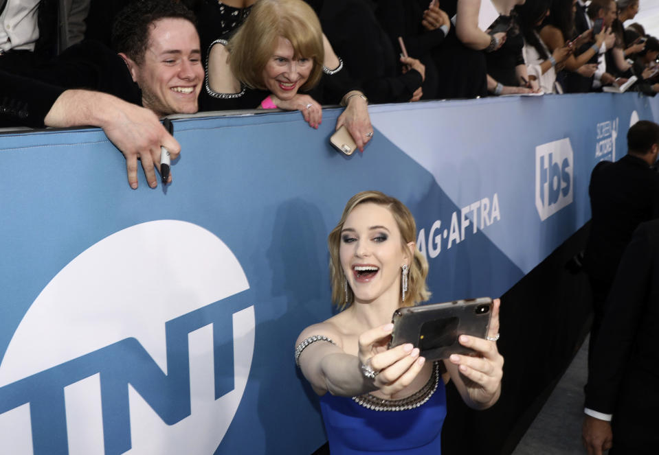 FILE - Rachel Brosnahan takes a selfie with fans as she arrives at the 26th annual Screen Actors Guild Awards on Jan. 19, 2020, in Los Angeles. Brosnahan turns 31 on July 12. (Photo by Matt Sayles/Invision/AP, File)