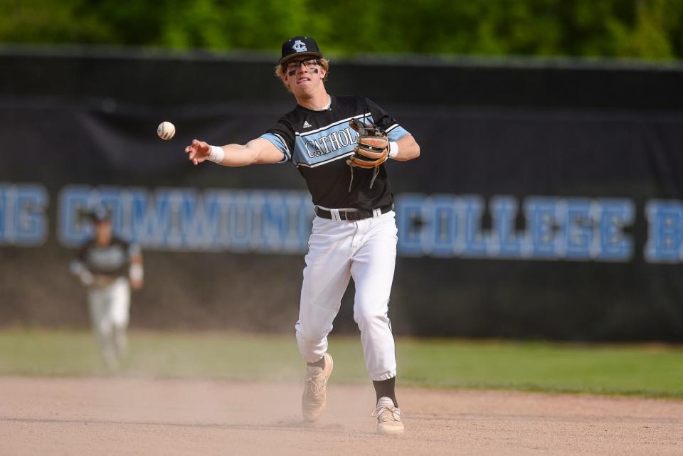 Lansing Catholic's Daniel Shipman throws an Olivet batter out during the third inning on Tuesday, May 23, 2023, at Kircher Municipal Park in Lansing.