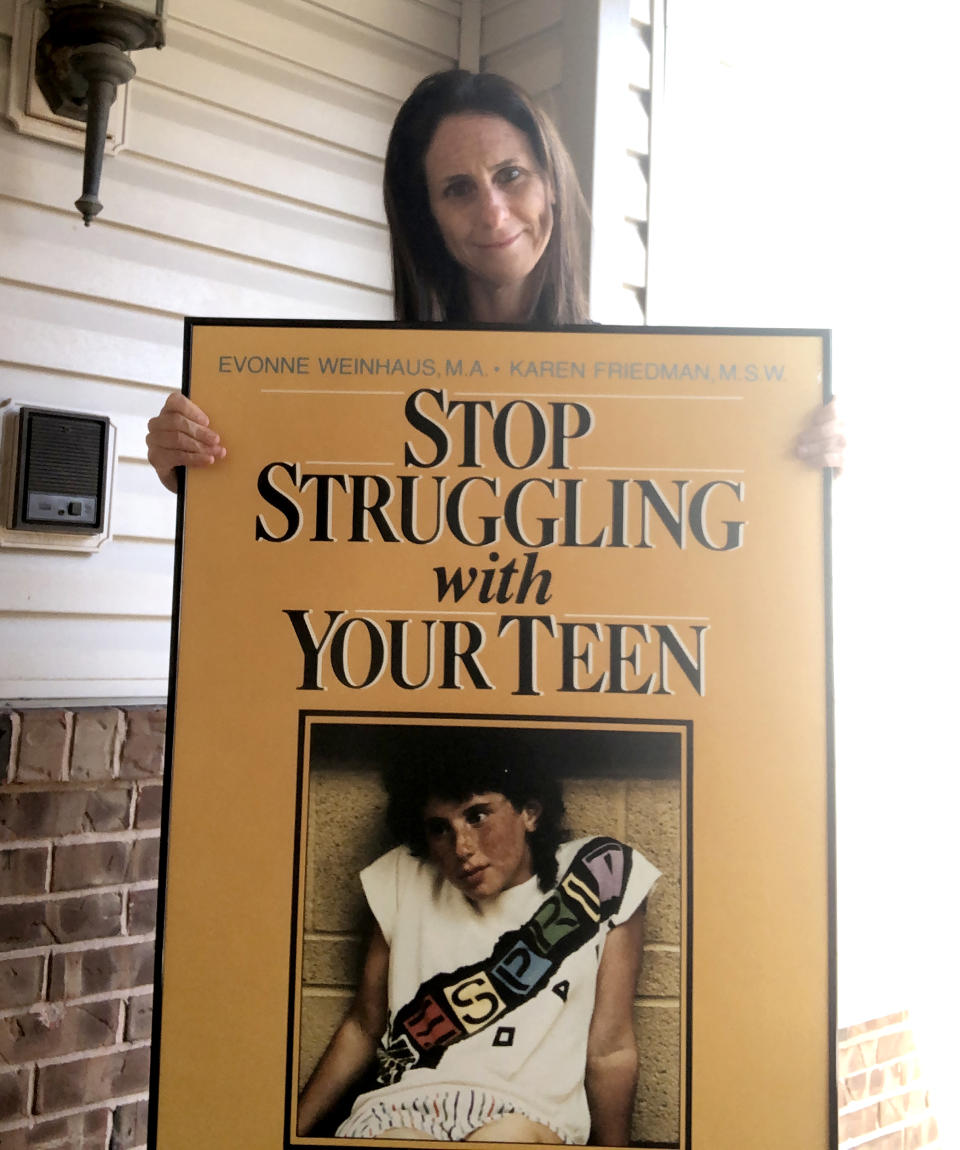 Me as an adult, with a poster-sized version of the book cover that my mom kept in her office. It was even in the background when TODAY interviewed her in the late 1980s. (Courtesy Rachel Weinhaus)