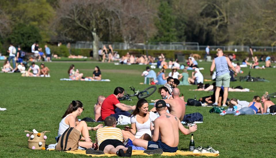 People enjoying the sunshine in Battersea Park, central London on Tuesday. (Getty)