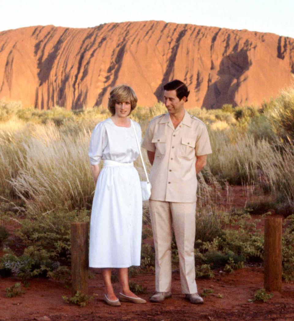 Prince Of Wales And Diana, Princess Of Wales Standing In Front Of Ayers Rock During Their Official Tour Of Australia