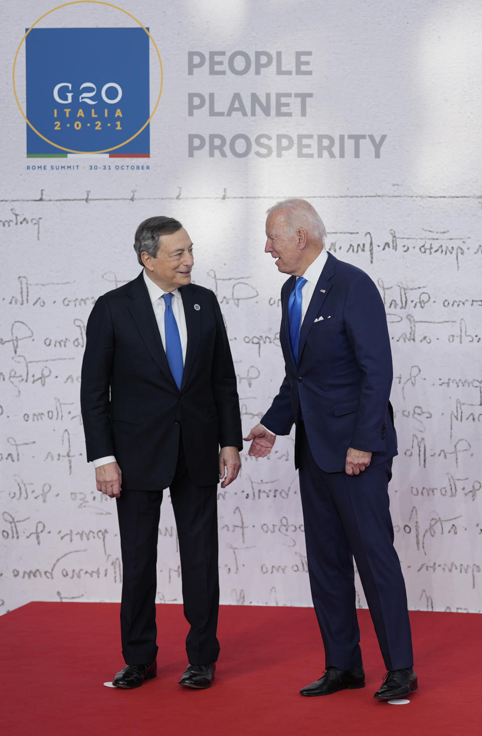 U.S. President Joe Biden, right, speaks with Italy's Prime Minister Mario Draghi as he arrives at the La Nuvola conference center for the G20 summit in Rome, Saturday, Oct. 30, 2021. The two-day Group of 20 summit is the first in-person gathering of leaders of the world's biggest economies since the COVID-19 pandemic started. (AP Photo/Domenico Stinellis)