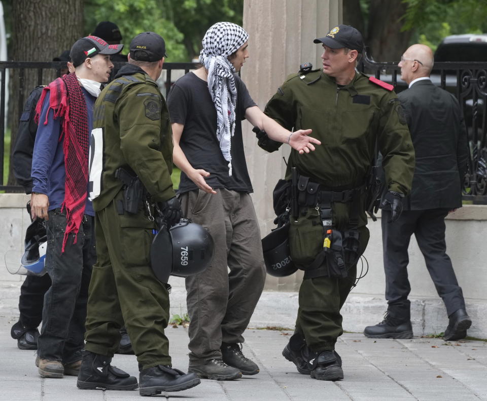 Protesters are removed as security clears the pro-Palestinian encampment at McGill University in Montreal, Wednesday, July 10, 2024. (Christinne Muschi/The Canadian Press via AP)