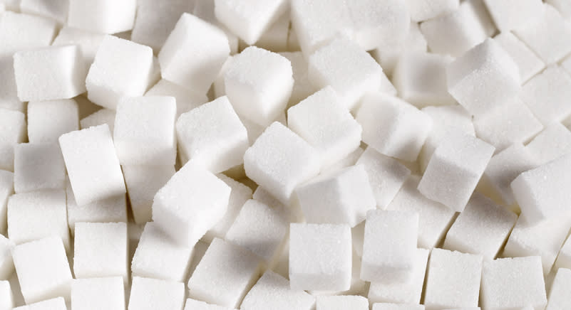 Close-up image of numerous white sugar cubes stacked together