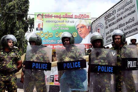 Special Task Force (STF) members stand guard in front of the Ceylon Petroleum Corporation during a strike by employees in Colombo, Sri Lanka July 26, 2017. REUTERS/Stringer