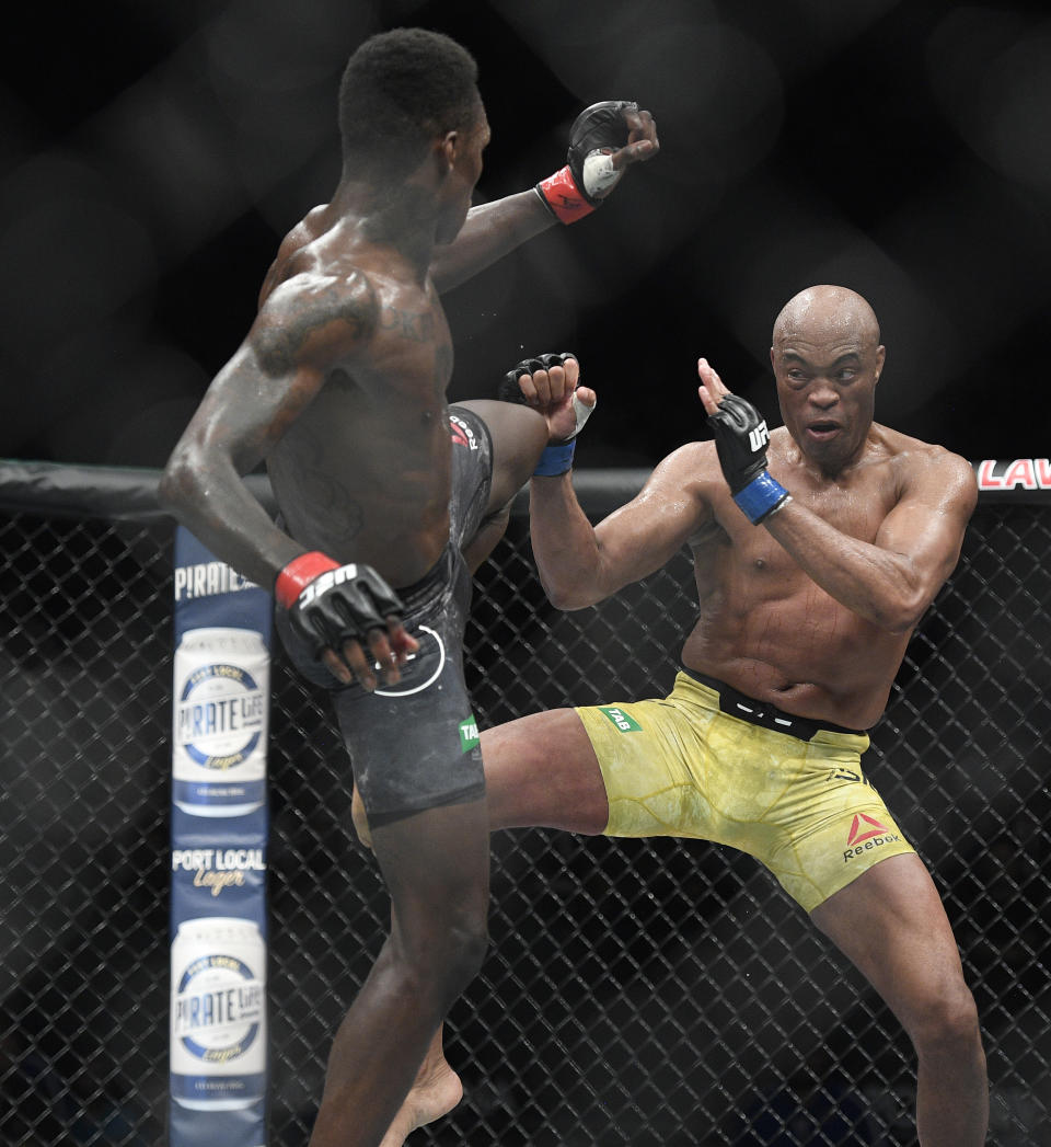 Nigeria's Israel Adesanya, left, and Brazil's Anderson Silva fight during their middleweight bout at the UFC 234 event in Melbourne, Australia, Sunday, Feb. 10, 2019. (AP Photo/Andy Brownbill)