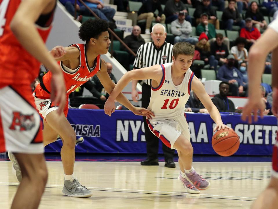 New Hartford's Connor Karwowski (10) drives to the basket against Amherst during the NYSPHSAA  Class A semifinal game at Cool Insuring Arena in Glens Falls, New York March 19, 2022. 