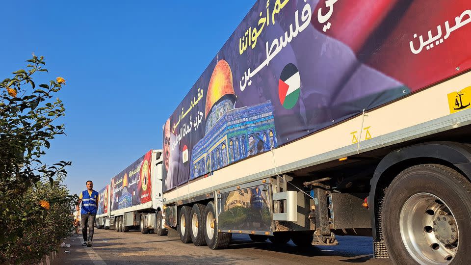 A convoy of trucks carrying aid supplies for Gaza from Egypt waits on the main Ismailia desert road, about 300 km east of the Egyptian border with Gaza, on October 16, 2023. - Khaled Desouki/AFP/Getty Images