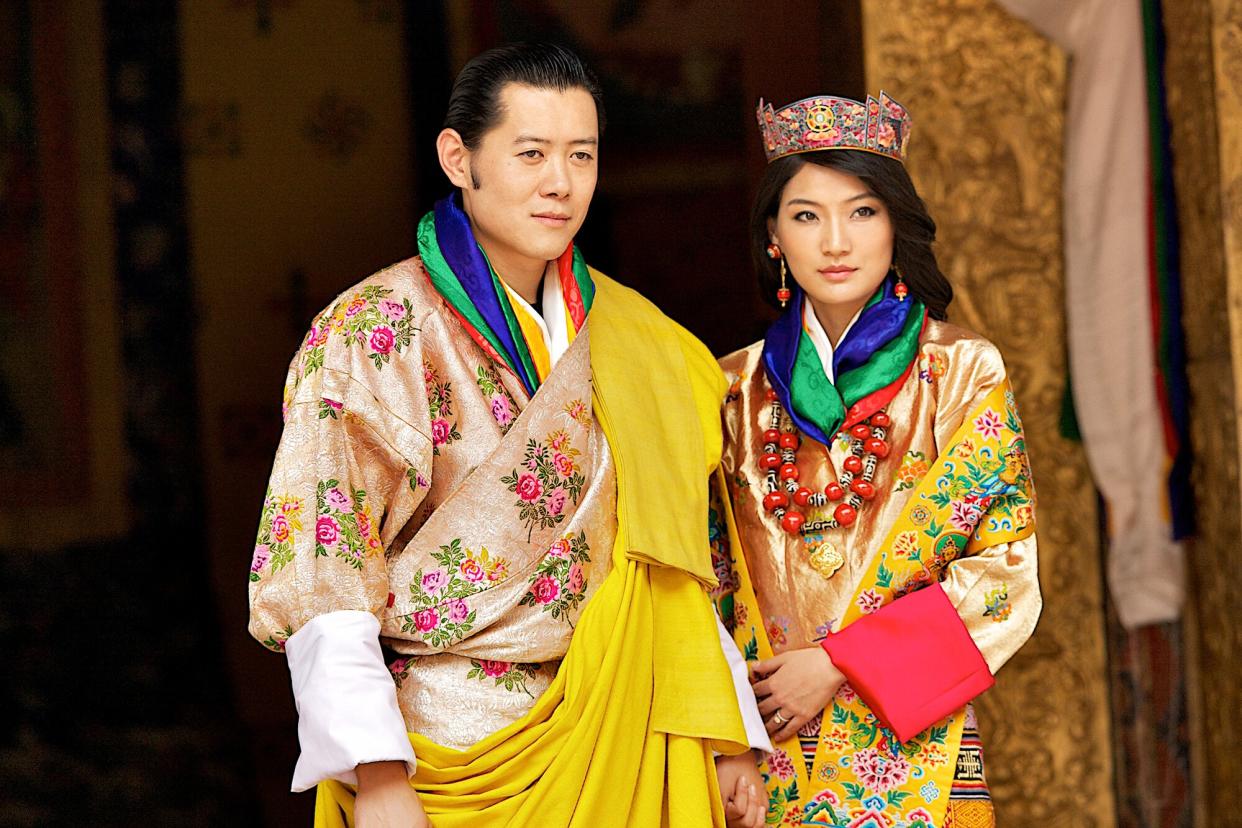 His majesty King Jigme Khesar Namgyel Wangchuck, 31, and Queen Jetsun Pema, 21, walk out after their marriage ceremony is completed on October 13, 2011 in Punakha, Bhutan.