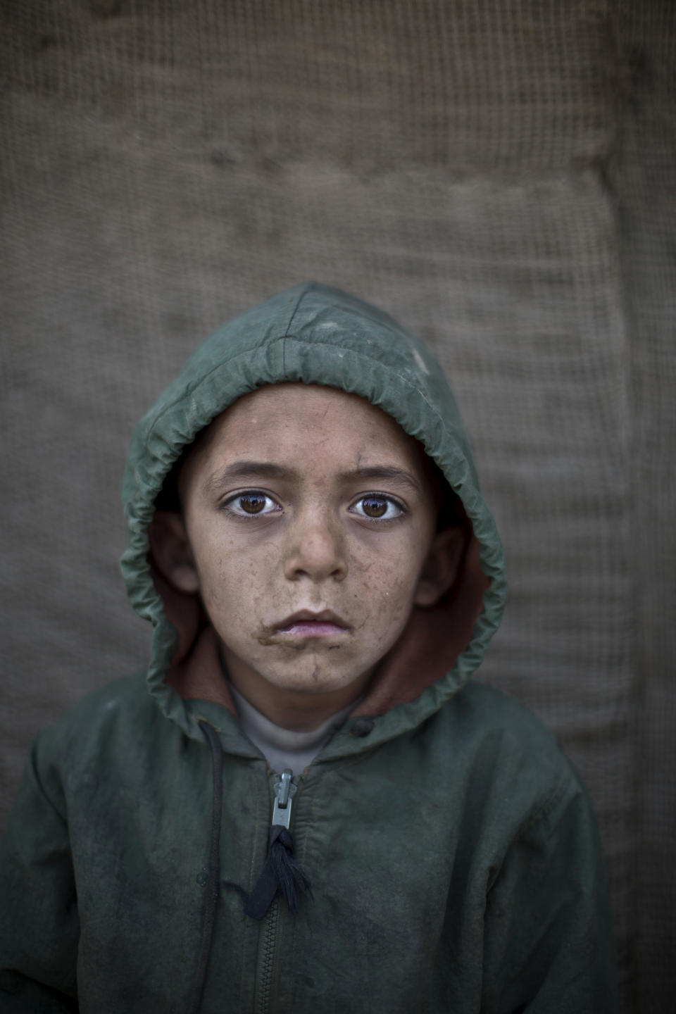 In this Saturday, Jan. 25, 2014 photo, Afghan refugee boy, Waheed Wazir, 6, poses for a picture, while playing with other children in a slum on the outskirts of Islamabad, Pakistan. For more than three decades, Pakistan has been home to one of the world’s largest refugee communities: hundreds of thousands of Afghans who have fled the repeated wars and fighting their country has undergone. Since the 2002 U.S.-led invasion of Afghanistan, some 3.8 million Afghans have returned to their home country, according to the U.N.’s refugee agency. (AP Photo/Muhammed Muheisen)