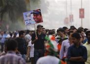 Cricket fans queue before a match outside a stadium in Mumbai November 14, 2013. Cricket-crazy India will have a lump in the throat as its favourite son, Sachin Tendulkar, walks out for one last time this week to play the game he has dominated for nearly a quarter of a century. The 'Little Master' will bring the curtain down on a glittering 24-year career at the age of 40 when he plays his 200th test match, against West Indies, at his home ground starting on Thursday. REUTERS/Danish Siddiqui \