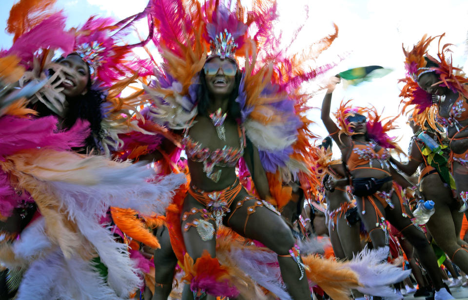 Masqueraders dance during the Caribbean Carnival parade in Toronto, Canada, Saturday, July 30, 2022. The 55th annual parade returned to the streets after the COVID-19 pandemic cancelled it for two years in a row. (AP Photo/Kamran Jebreili)