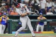 United States' Mike Trout hits a single during the first inning of a World Baseball Classic game against Venezuela, Saturday, March 18, 2023, in Miami. Mookie Betts scored on the play on a throwing error by Venezuela center fielder Ronald Acuna Jr. (AP Photo/Wilfredo Lee)