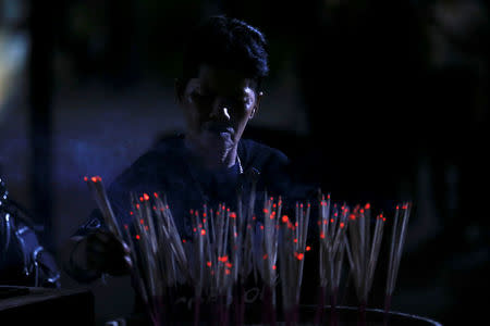 A Thai prays for Thailand's late King Bhumibol Adulyadej at the Siriraj hospital in Bangkok, Thailand, October 14, 2016. REUTERS/Chaiwat Subprasom