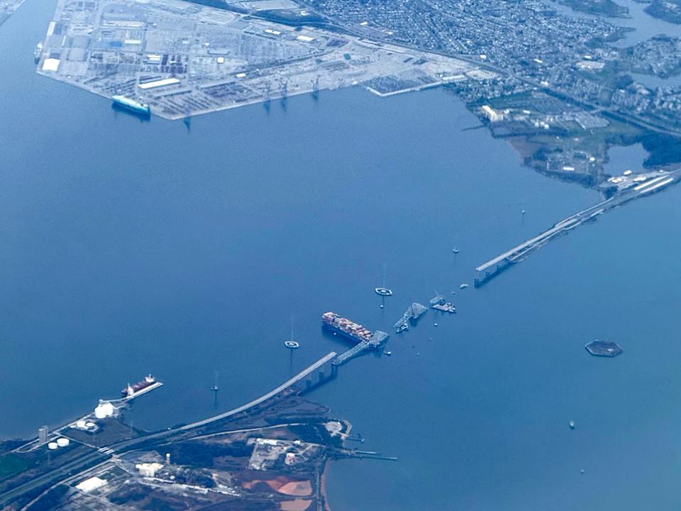This aerial view shows the collapsed Francis Scott Key Bridge lying on top of the container ship Dali in Baltimore (AFP via Getty Images)