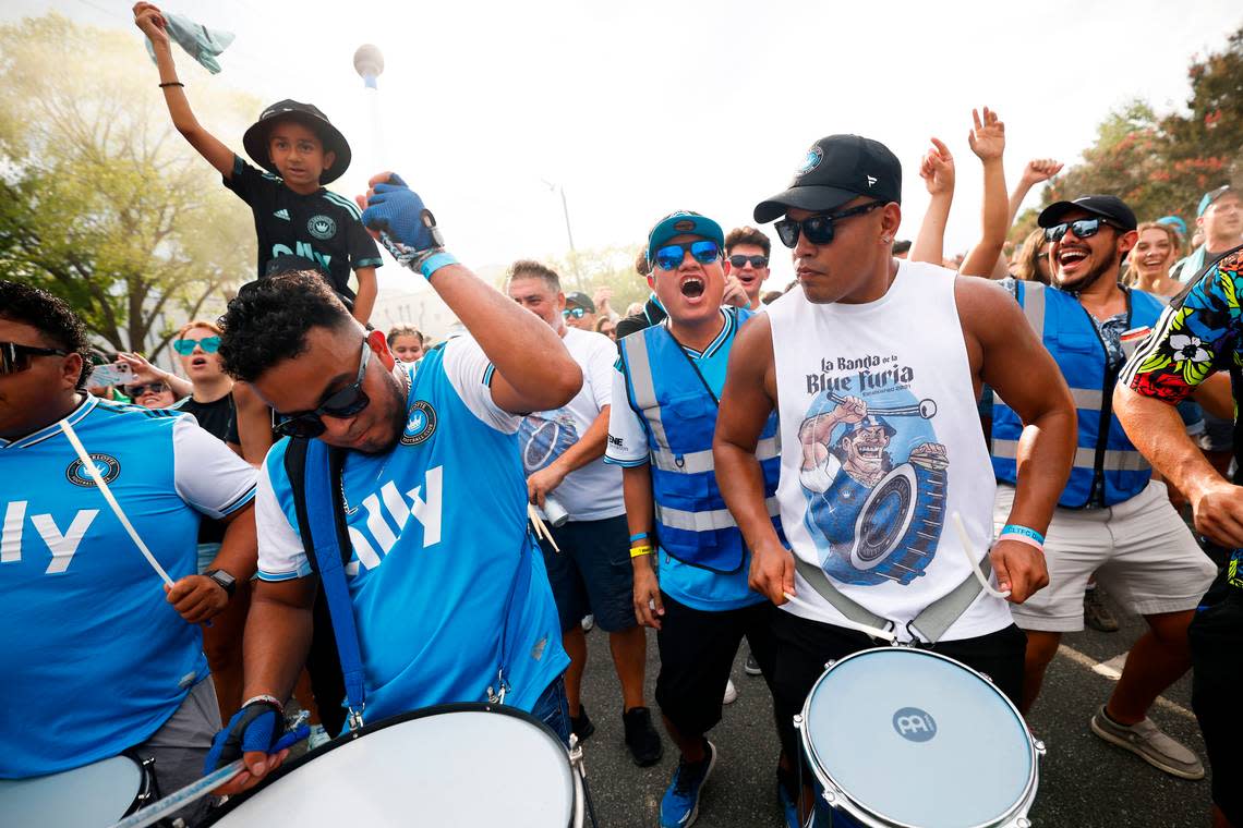 Charlotte FC fans march along Stadium View Drive on their way to the match between Charlotte FC and Columbus Crew at Bank of America Stadium in Charlotte, N.C., Saturday, July 30, 2022.