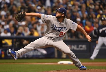 Oct 12, 2018; Milwaukee, WI, USA; Los Angeles Dodgers starting pitcher Clayton Kershaw (22) delivers a pitch during the first inning against the Milwaukee Brewers in game one of the 2018 NLCS playoff baseball series at Miller Park. Mandatory Credit: Benny Sieu-USA TODAY Sports