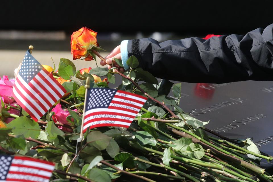 Flowers and flags are left by family and supporters on the panel with the names of those who died in the 1993 bombing of the World Trade Center. The National September 11 Memorial & Museum held a ceremony at the north pool of the 9/11 Memorial to commemorate the six victims of the February 26, 1993 World Trade Center bombing on the 29th anniversary of the attack. Following a moment of silence, family members read their loved ones’ names aloud and place roses at their names on the Memorial.