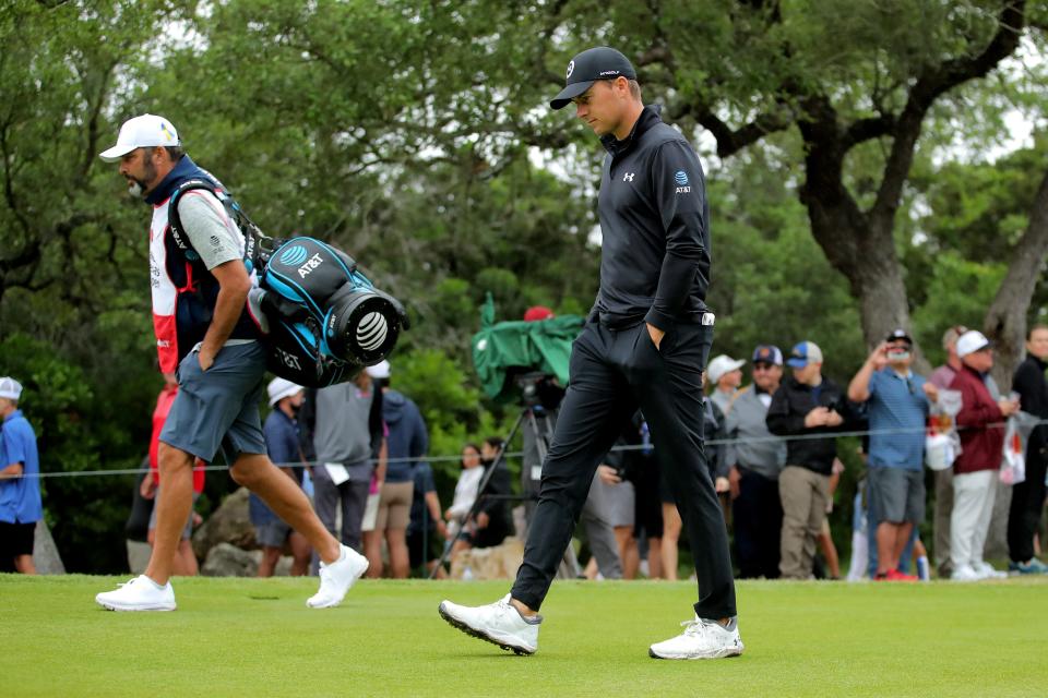 Jordan Spieth and his caddie walk down the fairway after teeing off on the first hole during the third round of the Valero Texas Open in San Antonio last weekend.