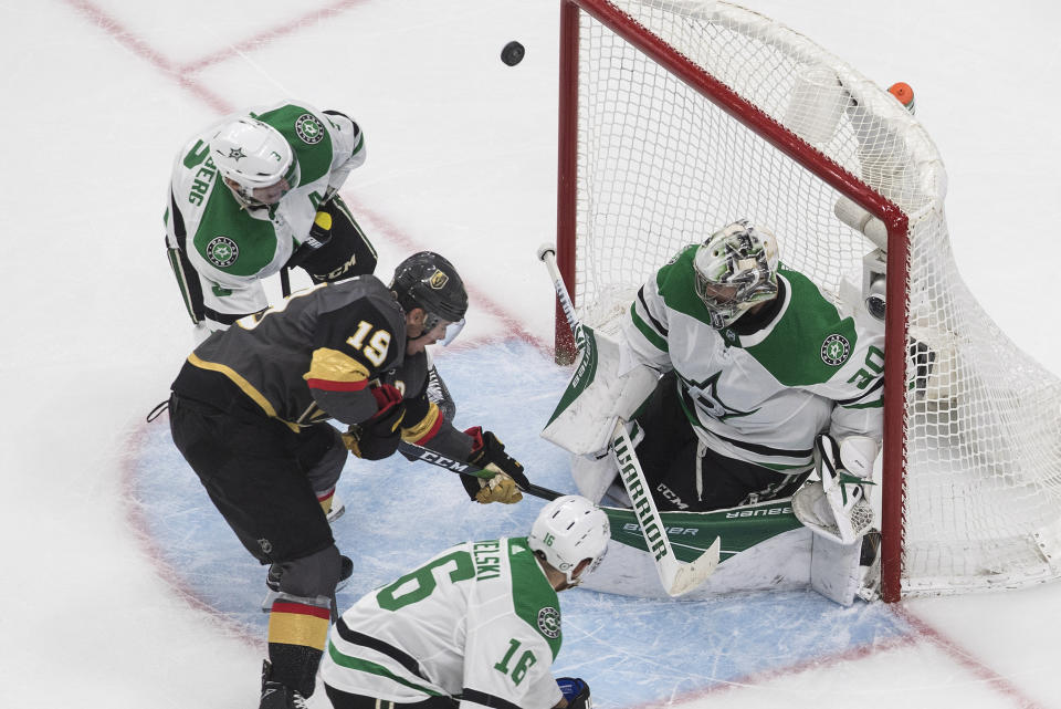 Dallas Stars goalie Ben Bishop (30) makes a save on Vegas Golden Knights' Reilly Smith (19) during the third period of an NHL hockey playoff game Monday, Aug. 3, 2020, in Edmonton, Alberta. (Jason Franson/The Canadian Press via AP)