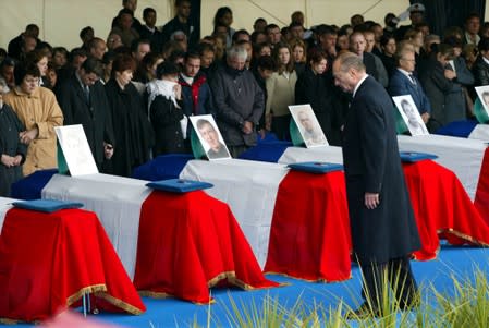 FILE PHOTO: French President Jacques Chirac pays tribute to the 11 Frenchmen killed in a suicide bomb attack in Karachi, Pakistan on May 8 during a ceremony in Cherbourg