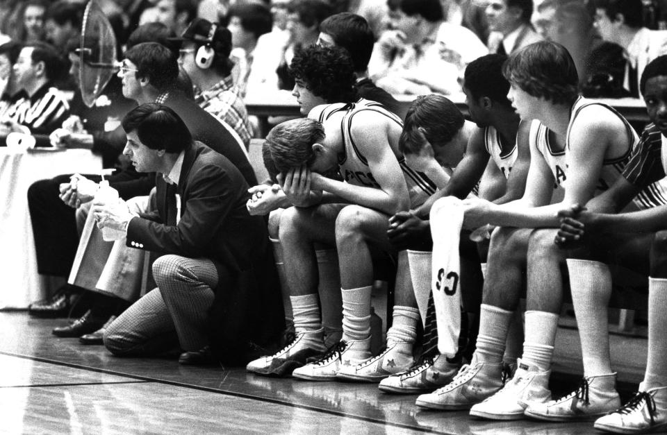 Barberton High School coaching legend Jack Greynolds Sr., kneeling to the far left, on the sideline in March 1981.