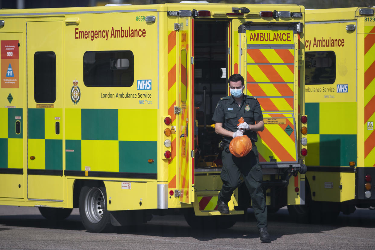 LONDON, UNITED KINGDOM - APRIL 10: A London ambulance worker leaves an ambulance outside the NHS nightingale hospital at the Excel on April 10, 2020 in London, England. Public Easter events have been cancelled across the country, with the government urging the public to respect lockdown measures by celebrating the holiday in their homes. Over 1.5 million people across the world have been infected with the COVID-19 coronavirus, with over 7,000 fatalities recorded in the United Kingdom.   (Photo by Justin Setterfield/Getty Images)