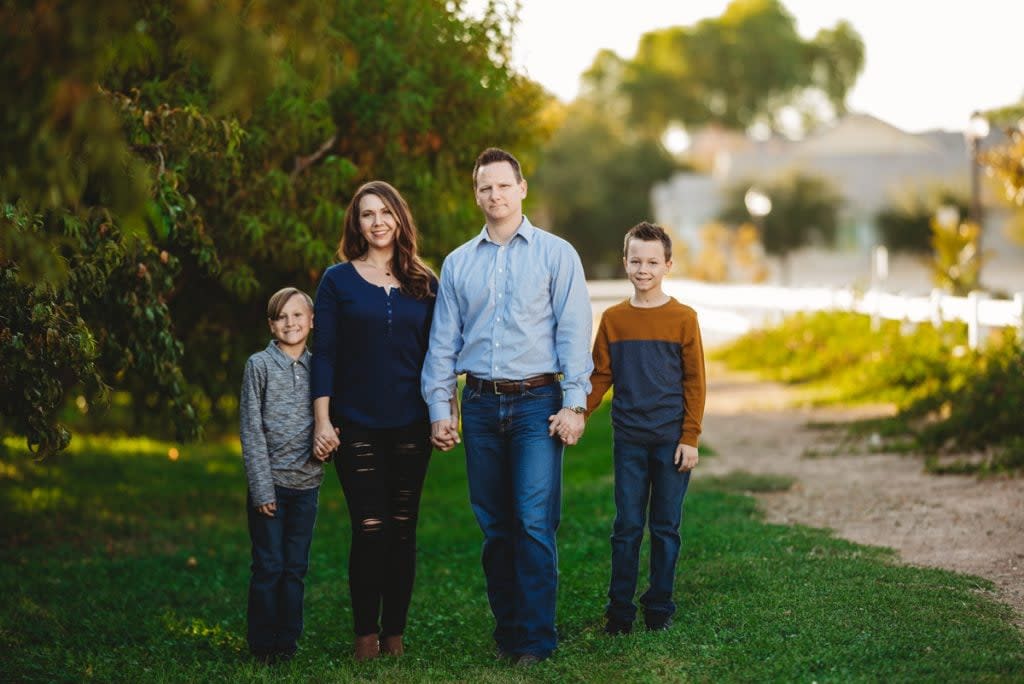 A family pose for a portrait outside.