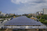 Cars pass by solar panels installed over the Beirut River, in Beirut, Lebanon, Thursday, May 30, 2024. Lebanese caretaker Minister of Economy and Trade Amin Salam said Lebanon's political class as well as fuel companies and private electricity providers in Lebanon blocked an offer by gas-rich Qatar to build three renewable energy power plants to ease the crisis-hit nation's decades-old electricity crisis. (AP Photo/Bilal Hussein)