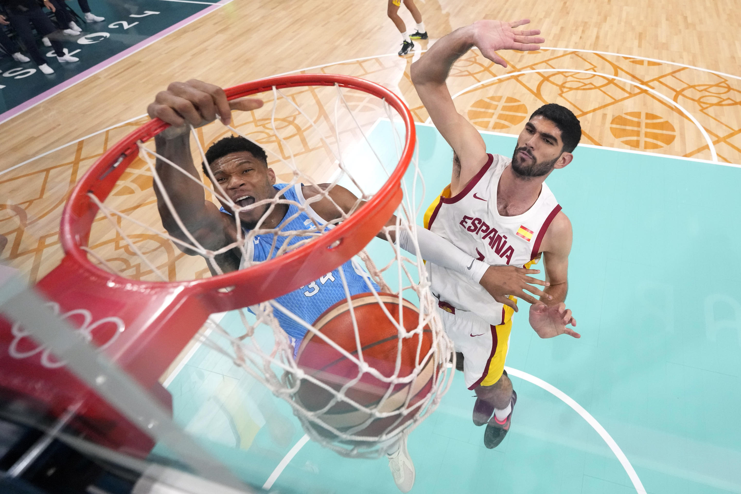 Greece's Giannis Antetokounmpo, left, dunks as Spain's Santi Aldama defends during a men's basketball game the 2024 Summer Olympics on July 30, 2024, in Villeneuve-d'Ascq, France. (Michael Conroy/Pool via AP)