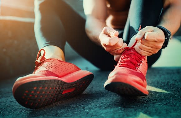 A jogger laces up.