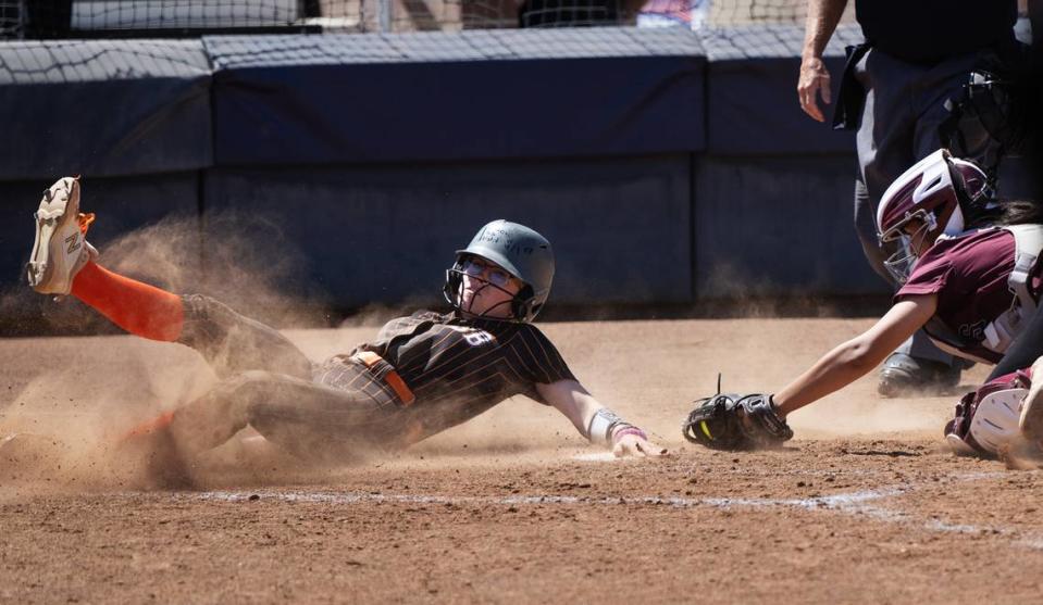 Summerville’s Madison Cribbs slides past the tag at home during the Sac-Joaquin Section Division VI championship game with Riverbank at Cosumnes River College in Sacramento, Calif., Saturday, May 20, 2023. Summerville won the game 4-1.