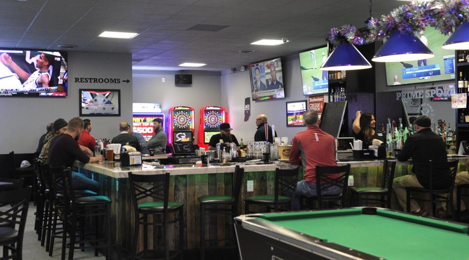 Customers gather around the bar at Prime Sports on Friday, Dec. 1, 2023.