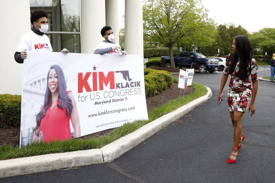 Kimberly Klacik, right, the Republican candidate in the 7th Congressional District special election, greets campaign supporters outside of a voting center, Tuesday, April 28, 2020, in Windsor Mill, Md. Klacik is going up against Democrat Kweisi Mfume in the election to fill a seat left open by the death last October of Congressman Elijah Cummings. An election that has been dramatically reshaped by the coronavirus outbreak. (AP Photo/Julio Cortez)