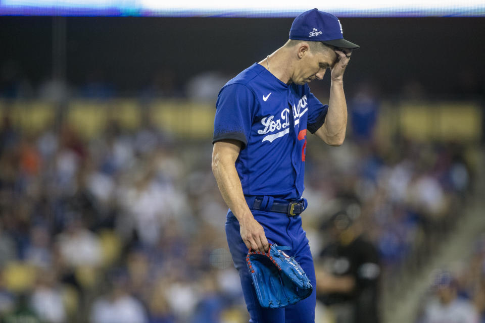 Los Angeles Dodgers' Walker Buehler walks off the field after manager Dave Roberts pulls Buehler during the third inning of a baseball game against the New York Mets in Los Angeles, Saturday, June 4, 2022. (AP Photo/Alex Gallardo)