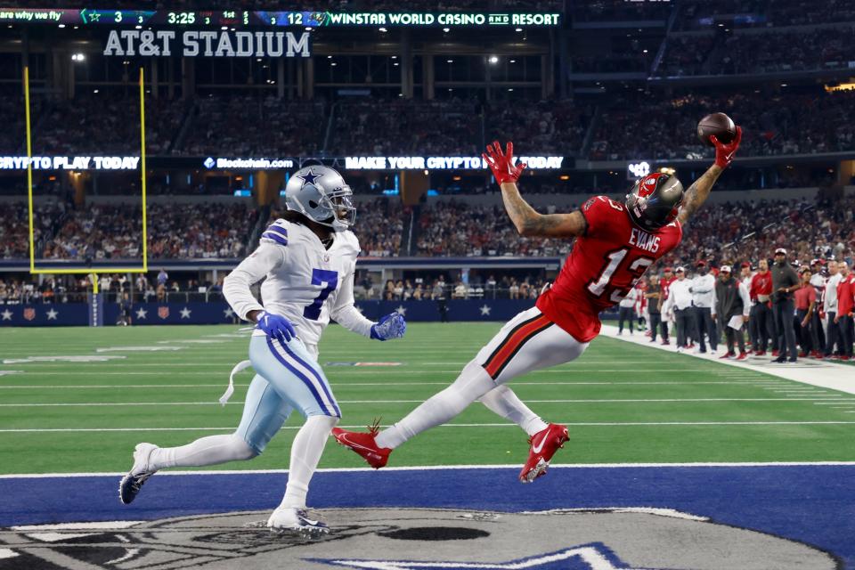 Tampa Bay Buccaneers wide receiver Mike Evans (13) catches a touchdown pass as Dallas Cowboys cornerback Trevon Diggs (7) defends in the second half of a NFL football game in Arlington, Texas, Sunday, Sept. 11, 2022. (AP Photo/Michael Ainsworth)