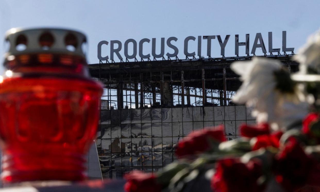 <span>Candles and flowers lie outside the burned-out Crocus City Hall. Moscow is still accusing Ukraine of being behind the attack.</span><span>Photograph: Maxim Shemetov/Reuters</span>