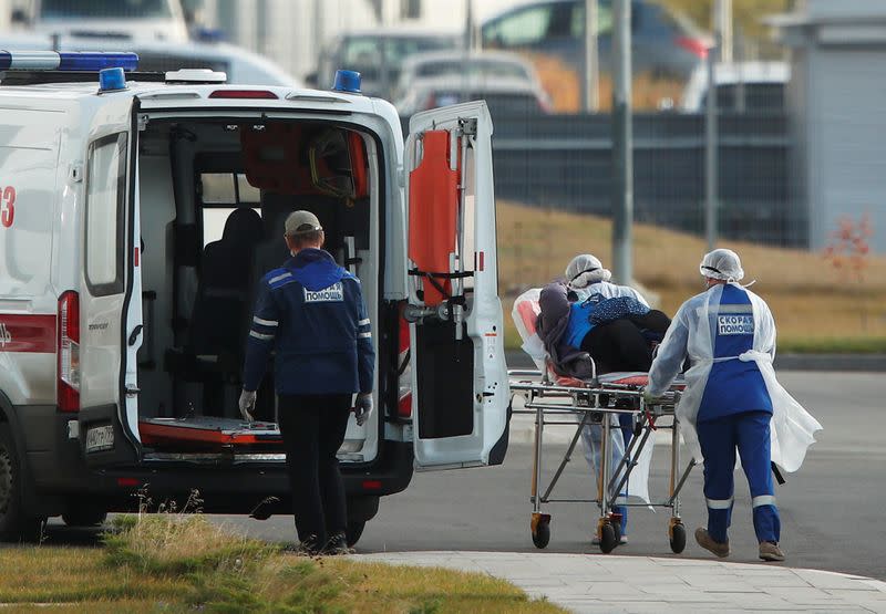 FILE PHOTO: Medical specialists transport a person on a stretcher outside a hospital for patients infected with coronavirus disease in Moscow