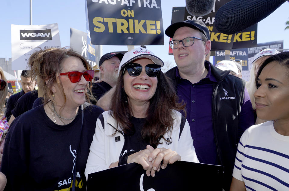 File - Actor Joely Fisher, from left, SAG-AFTRA president Fran Drescher and Duncan Crabtree-Ireland, SAG-AFTRA national executive director and chief negotiator, take part in a rally by striking writers and actors outside Netflix studio in Los Angeles on July 14, 2023. Drescher took over as president of the Screen Actors Guild-American Federation of Television and Radio Artists in September 2021 and has become a firebrand, as well as the face and voice of the top creative minds in Hollywood, over the past few months. (AP Photo/Chris Pizzello, File)